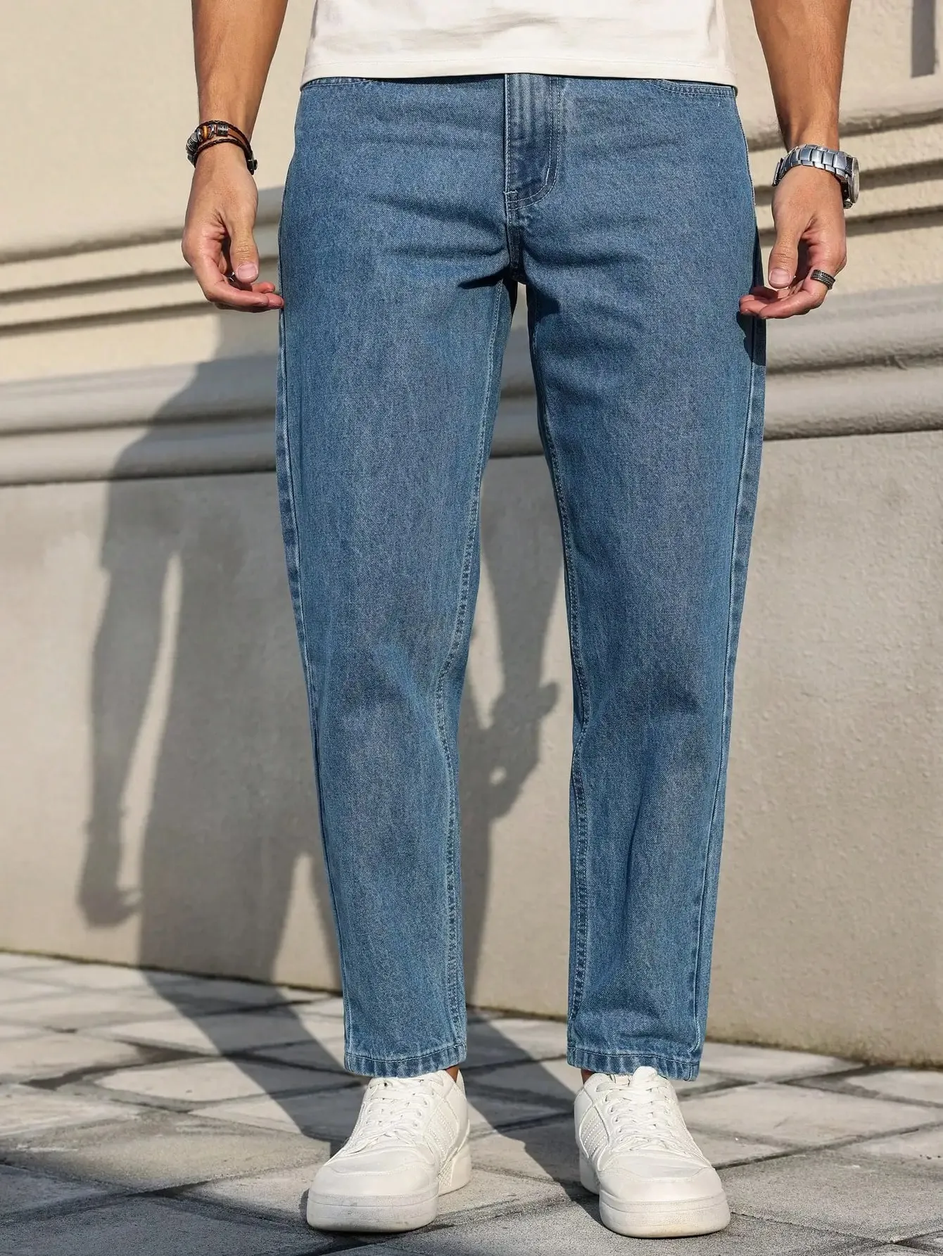 Men's Jeans Are Made of Classic Blue Denim Fabric with a Loose Fit Making Them an Indispensable Versatile Item in the Wardrobe.